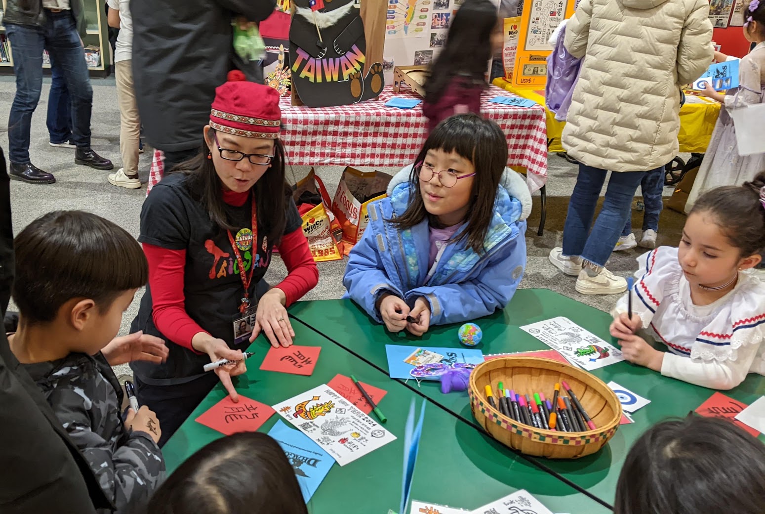 賴筱雯指導小朋友書寫正體漢字斗方春聯