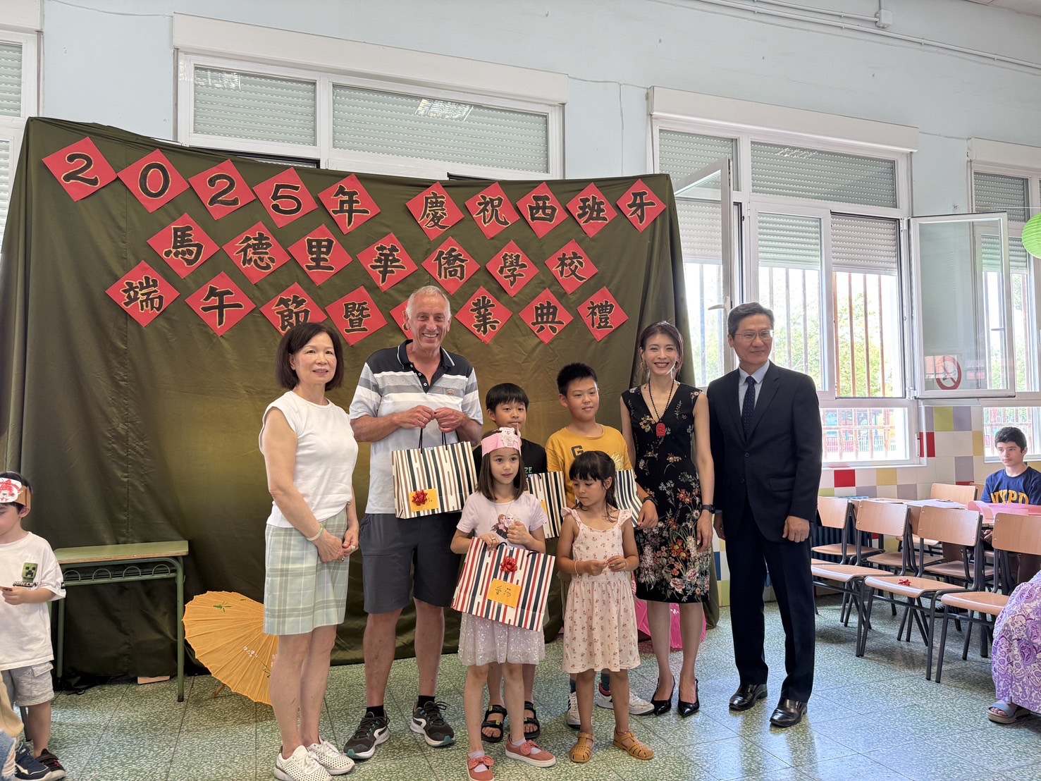 TCML成人與僑校學生一起上台領接受優秀學生獎品