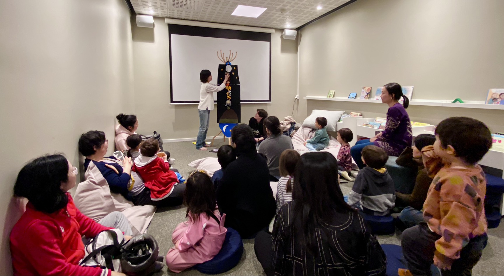 透過繪本教具及成人學生翻譯引導孩子認識故事內容