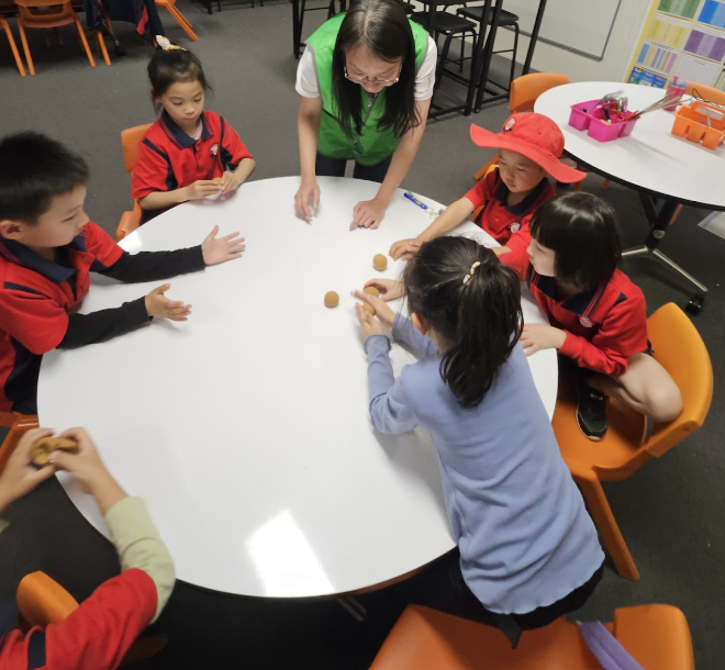 老師指導學生手作輕黏土月餅，孩子們專注創作、樂在其中。