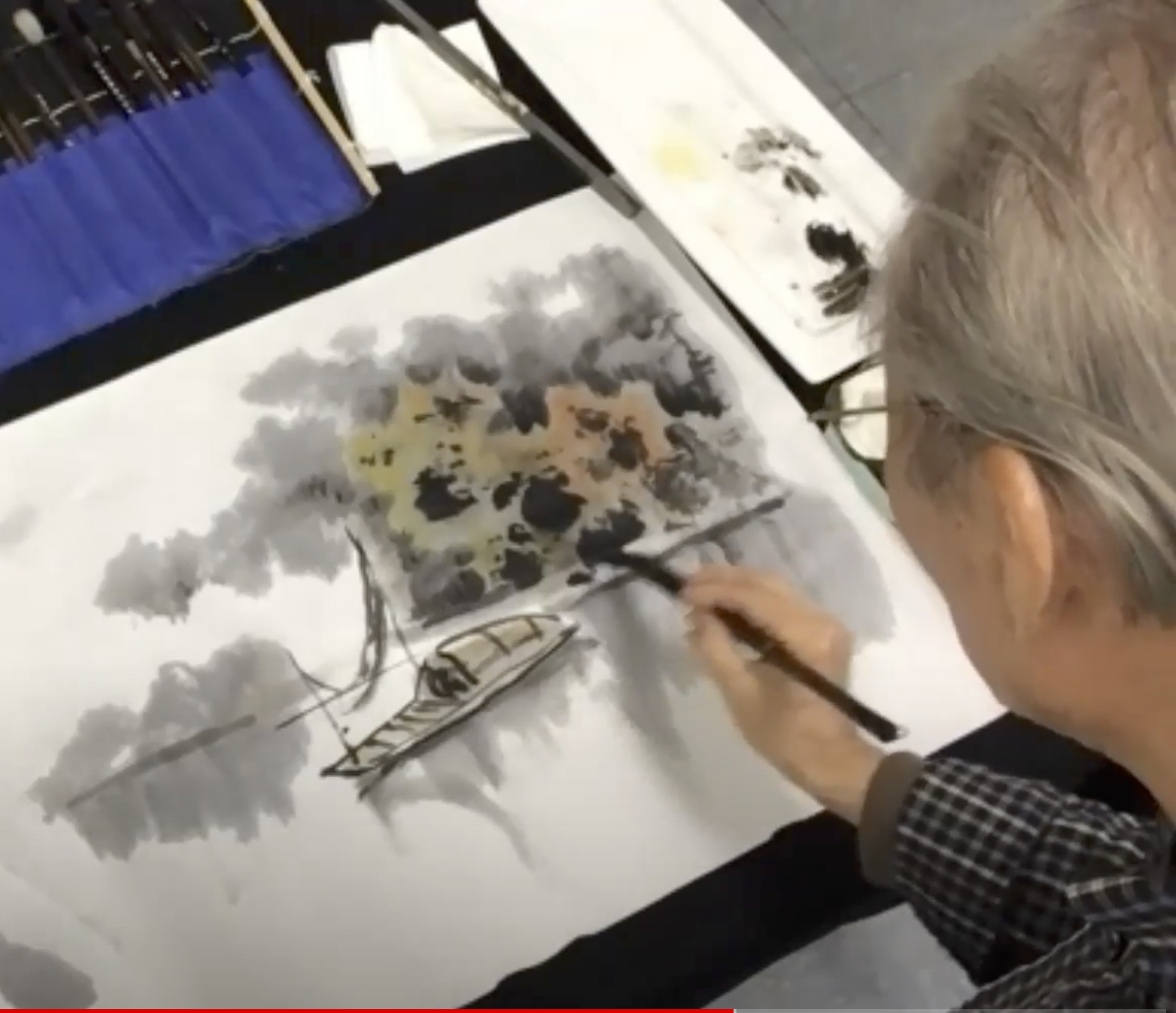 李樹人老師在鏡頭下揮毫，當場解說示範運筆方法。